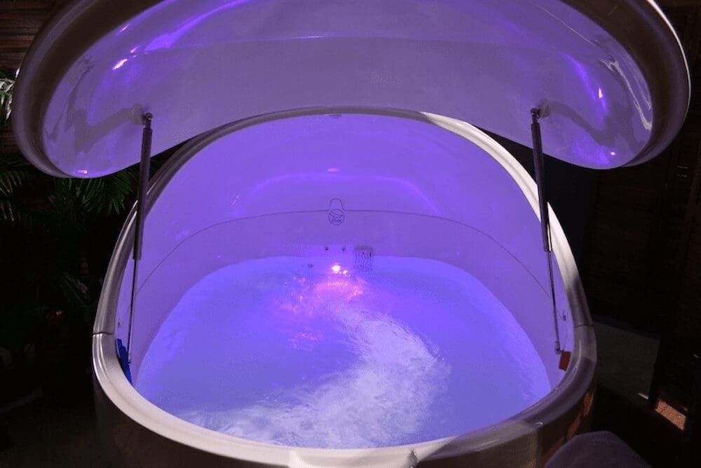 A serene view of the Dream Pod magnesium float tank with pricing details for 30 and 60-minute sessions.