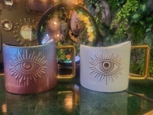 Two coffee cups sold at the Grounding Shop